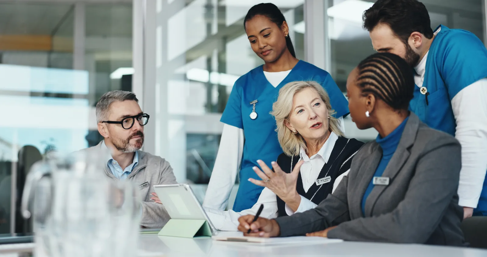Hospital leadership team in conversation with clinical staff
