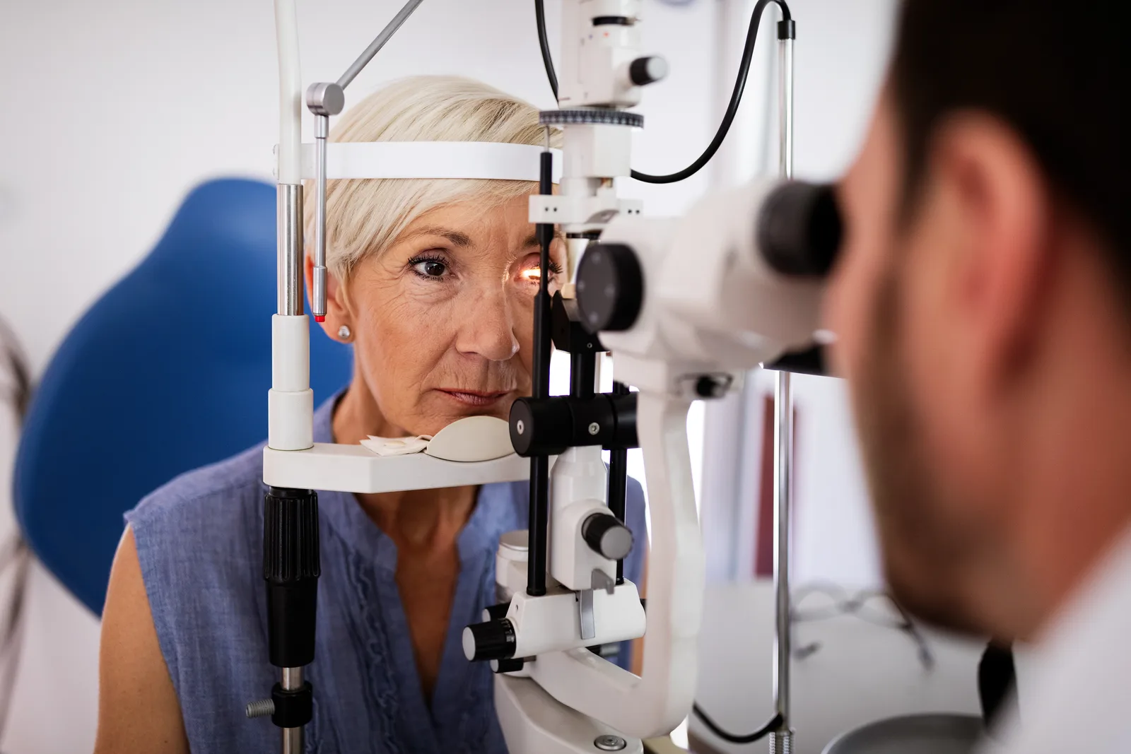 Patient receiving an eye examination with a slit lamp