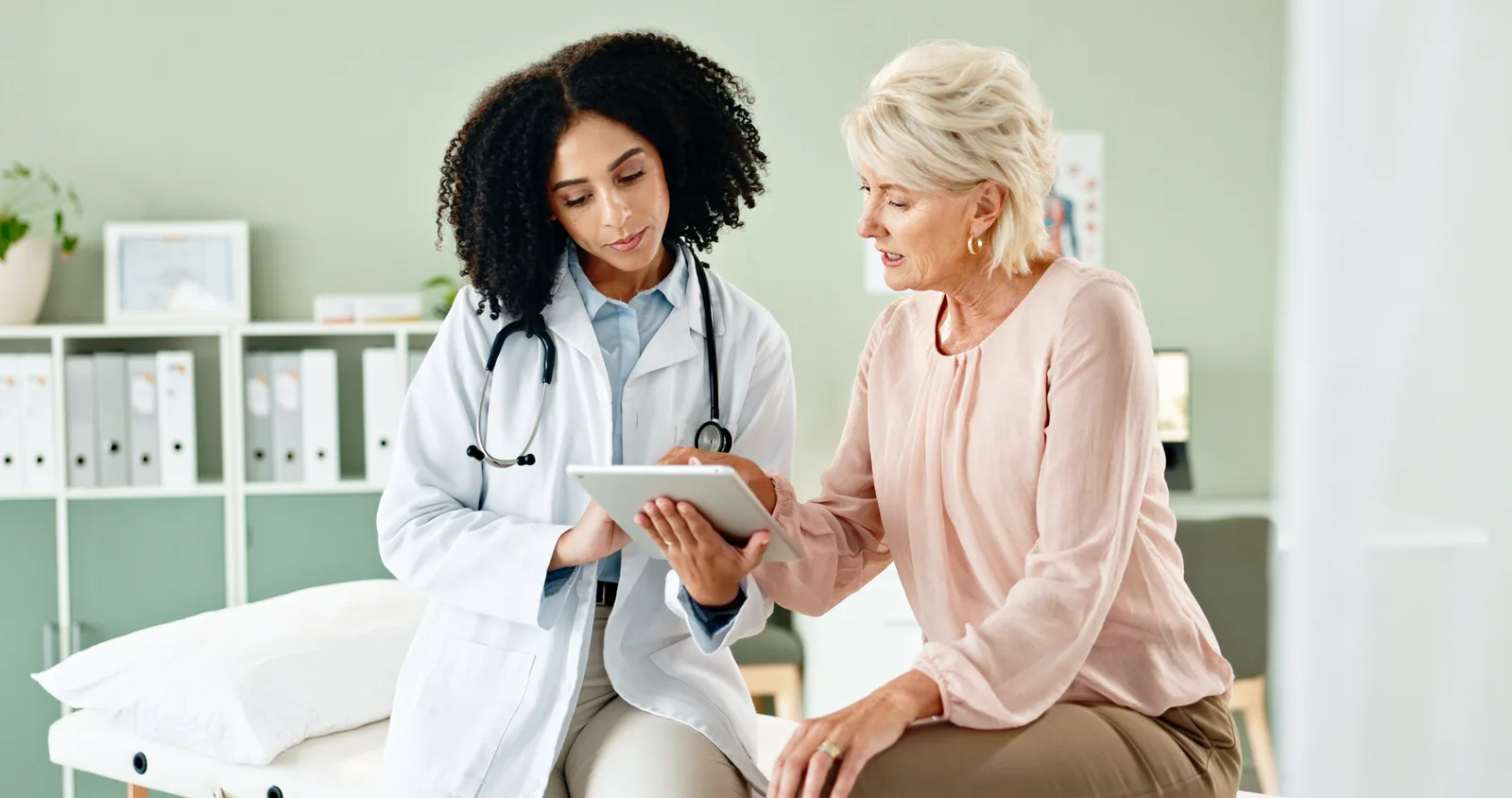Doctor and older patient reviewing information together
