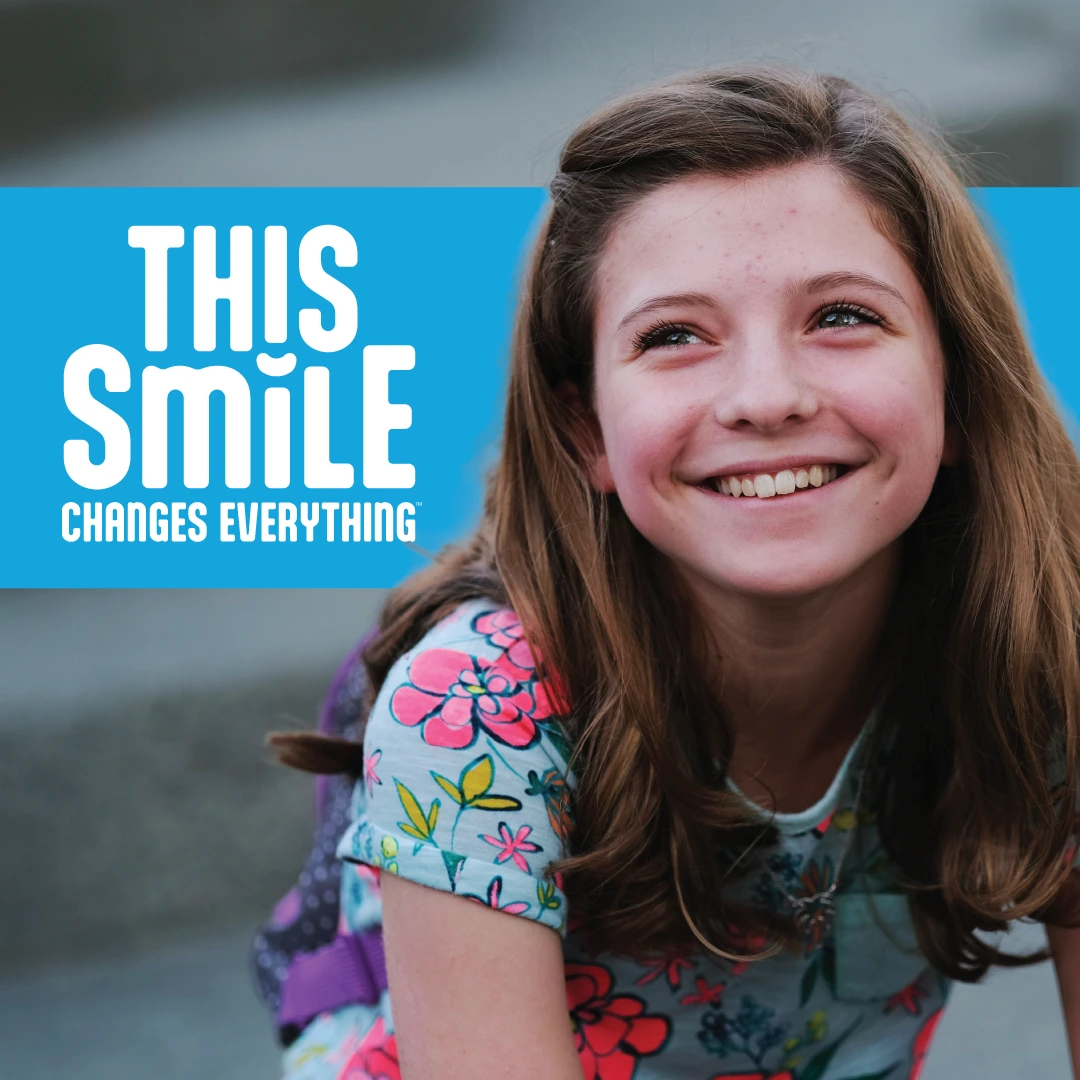 Square Spotify campaign card for This Smile Changes Everything showing a smiling girl